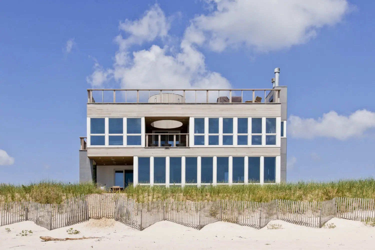 Three-story beachfront home with floor-to-ceiling windows