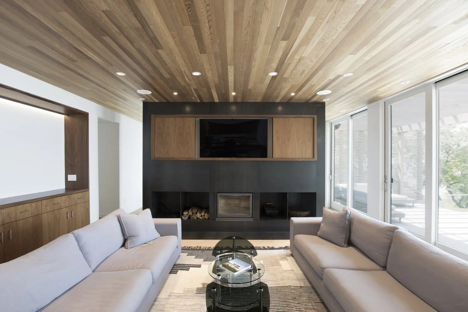 Modern living room with neutral tones and a sleek fireplace.