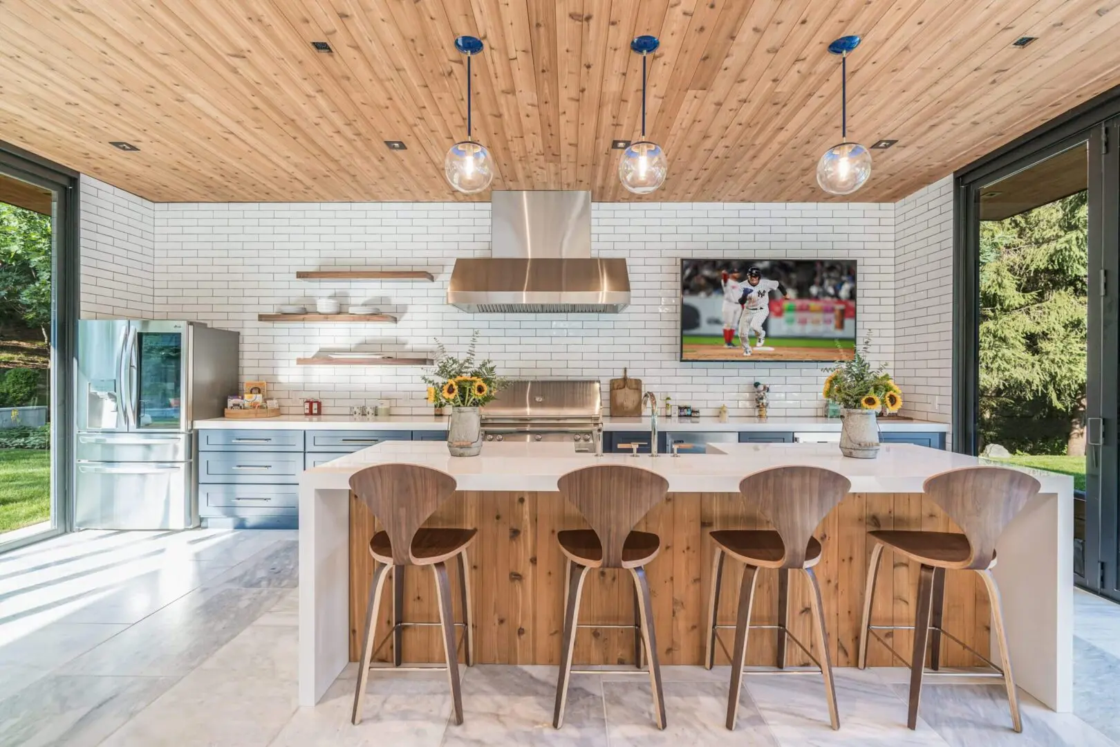 Modern kitchen with wooden accents and stylish bar stools.