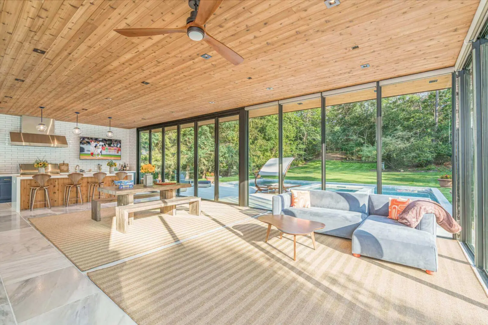 Bright living room with large glass doors opening to a garden.