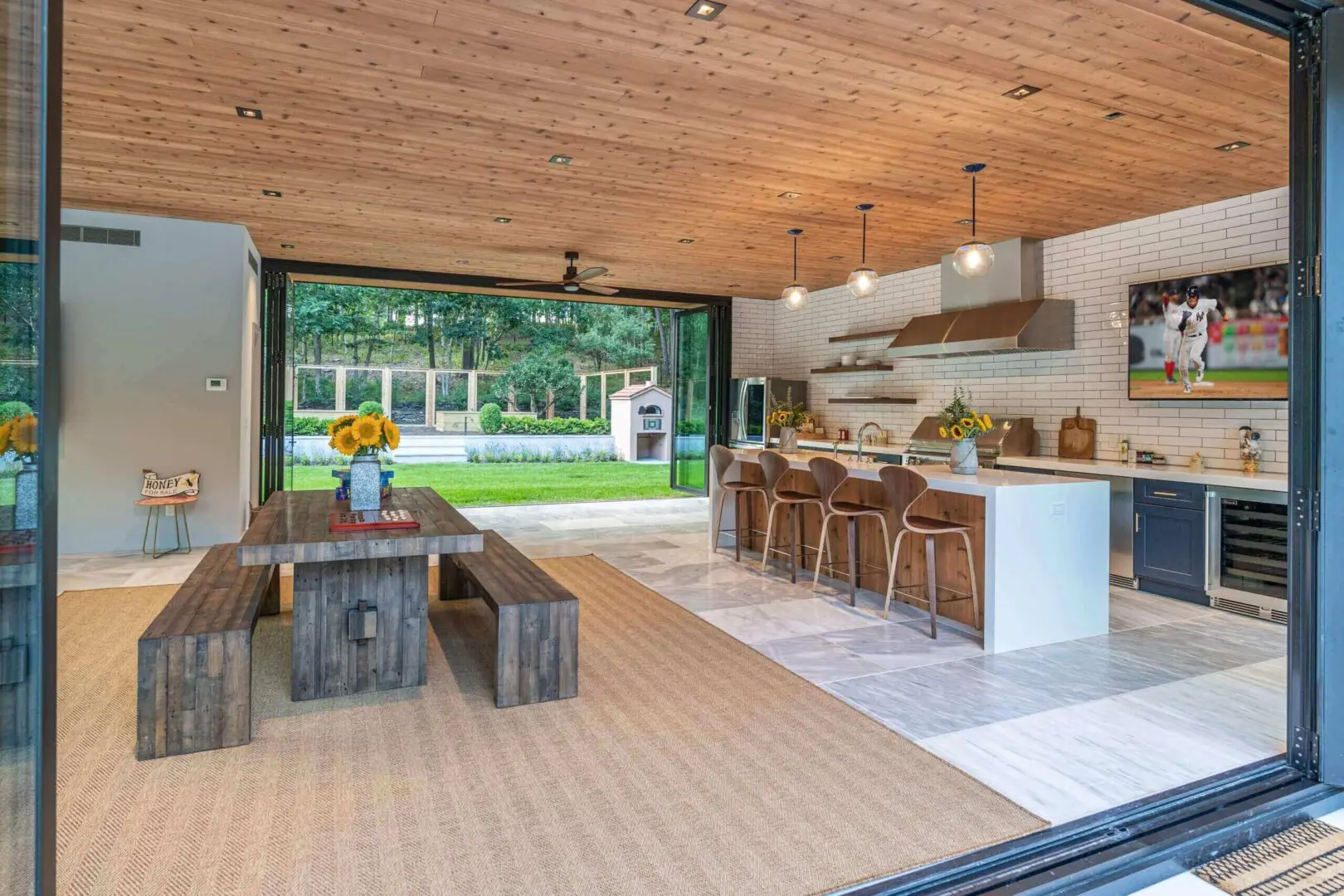 Open-concept kitchen and dining area with rustic and modern design elements.