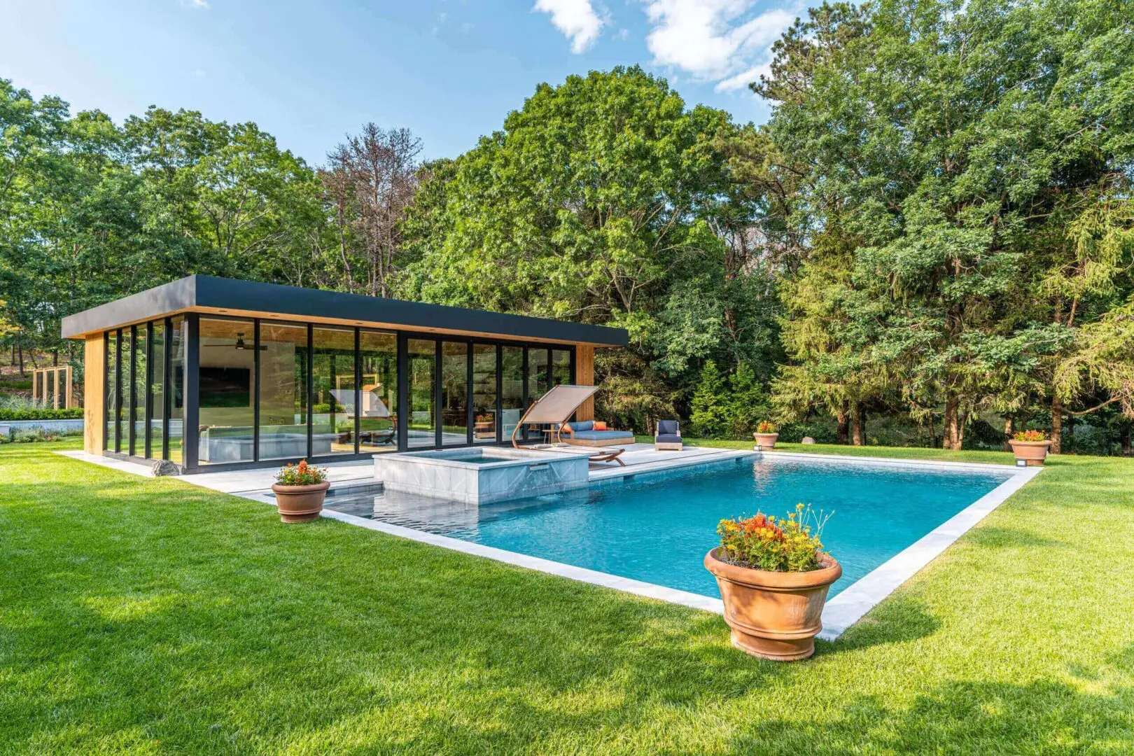 Modern glass pool pavilion with raised spa