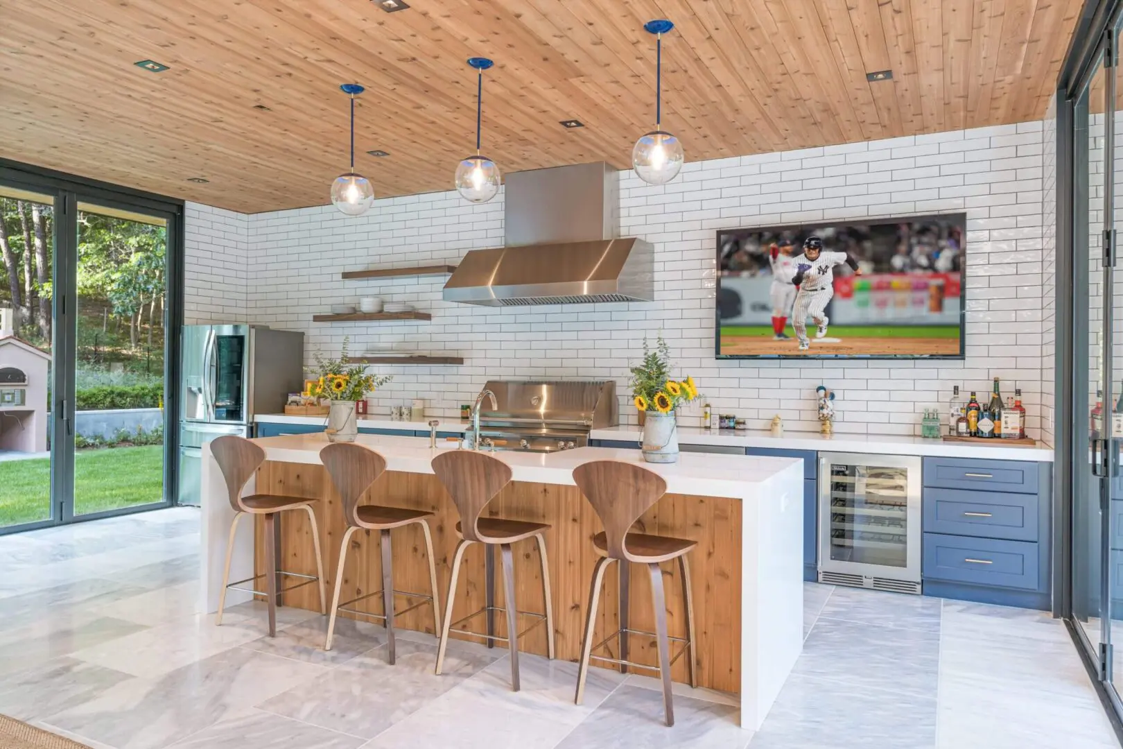 Open kitchen with wooden island and stools