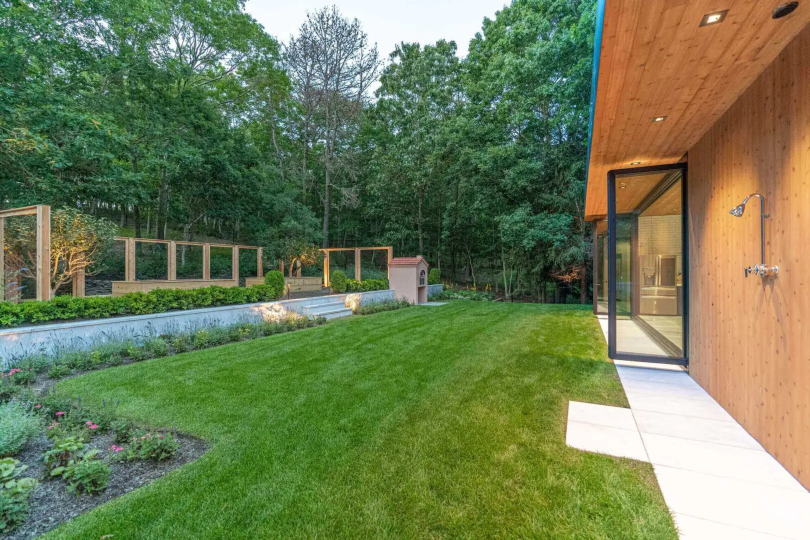 Modern home with a spacious backyard and lush green lawn.