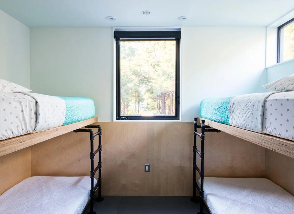 Cozy bunk beds in a bright, minimalist room with a window.