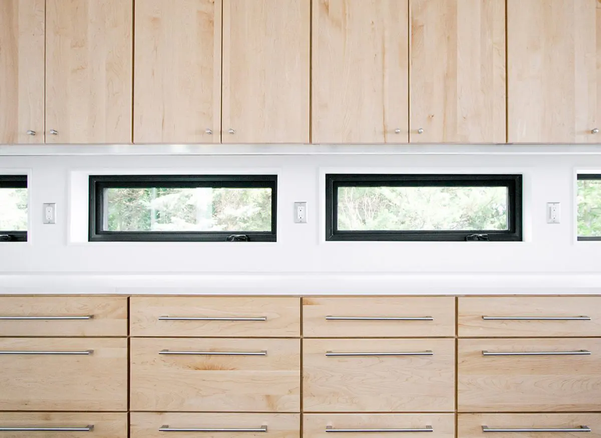 Modern kitchen cabinets with horizontal windows above.
