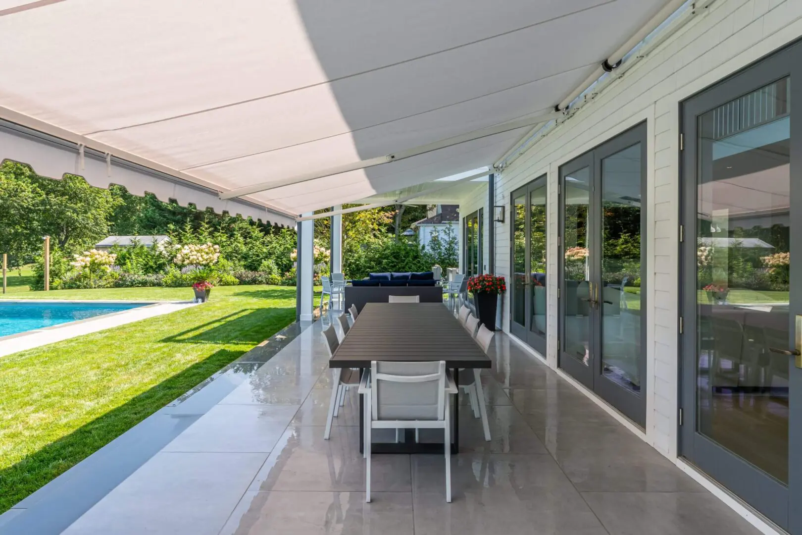 Modern outdoor patio with dining area and retractable awning.