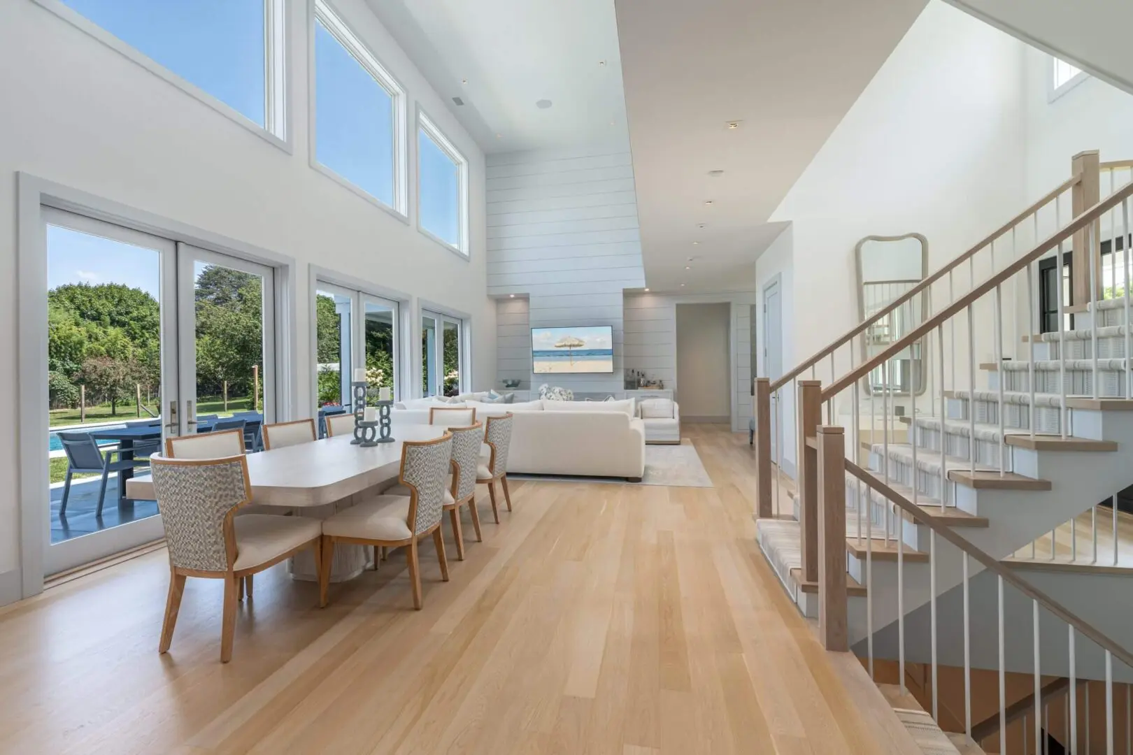 Bright modern living space with wooden floors and large windows.