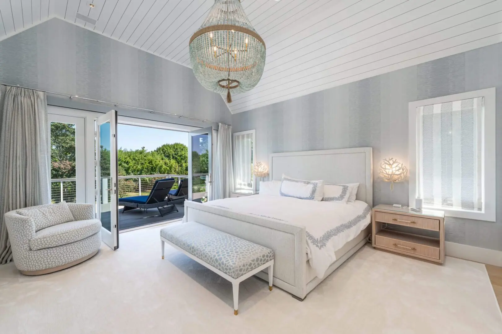 Bright and airy bedroom with a large bed and balcony view.