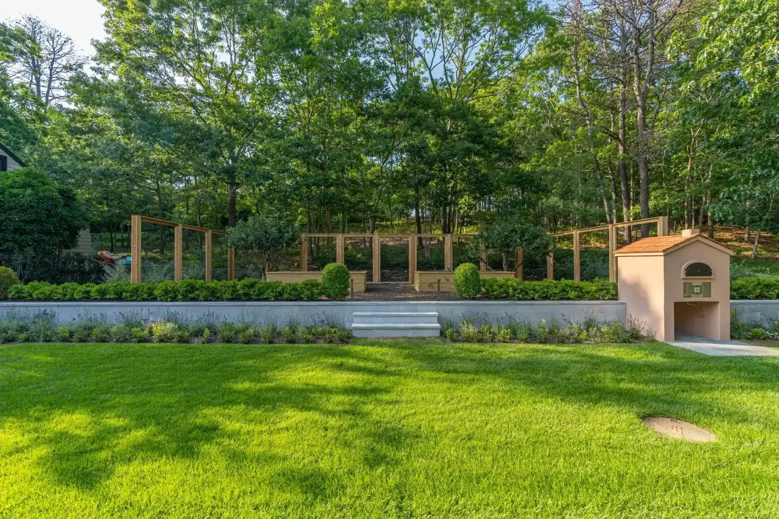 Green lawn with terraced raised wooden garden beds